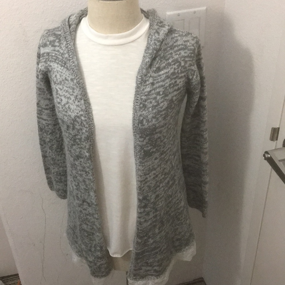 Cute sparkly gray sweater with laces on the bottom